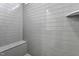 Clean shower with gray tile and built-in seat at 444 Billingshurst Way, Knightdale, NC 27545