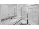 Modern bathroom featuring a granite-topped vanity and a glass-enclosed shower with built-in shelving at 657 Sun Meadow Dr, Wake Forest, NC 27587
