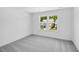 Bright bedroom with plush carpeting and a large window providing plenty of natural light at 657 Sun Meadow Dr, Wake Forest, NC 27587