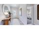 Bright entryway featuring a wood console table, decorative mirror, and view to a bedroom at 657 Sun Meadow Dr, Wake Forest, NC 27587