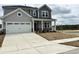 Charming two-story home with a two-car garage and beautifully landscaped front yard at 657 Sun Meadow Dr, Wake Forest, NC 27587