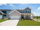 Charming two-story home features a well-manicured lawn, attached two car garage, and craftsman style architecture at 657 Sun Meadow Dr, Wake Forest, NC 27587