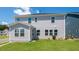 Back exterior view of this home with siding, multiple windows, and a well-maintained yard at 657 Sun Meadow Dr, Wake Forest, NC 27587