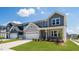 Charming home featuring a well-manicured lawn, stone accents, and a two-car garage at 657 Sun Meadow Dr, Wake Forest, NC 27587