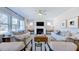 Well-lit living room featuring a fireplace, comfortable couches, and views from multiple windows at 657 Sun Meadow Dr, Wake Forest, NC 27587