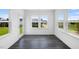 Open concept sunroom features hardwood floors, plenty of natural light, and an exit to the backyard at 657 Sun Meadow Dr, Wake Forest, NC 27587