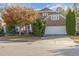 Charming brick home with a two-car garage, complemented by mature trees and manicured landscaping at 719 Allforth Pl, Cary, NC 27519