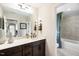 Modern bathroom features a long mirror, granite countertop, and a shower and tub combo at 905 Delano Dr, Knightdale, NC 27545