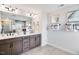 Sleek bathroom featuring double sinks, a large mirror, and modern fixtures with neutral wall art at 905 Delano Dr, Knightdale, NC 27545
