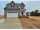Charming two-story home featuring a two-car garage and beautiful, newly installed landscaping at 95 Mapledale Ct, Benson, NC 27504