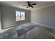 Empty bedroom with neutral walls, carpet flooring, a large window, and bright natural light at 32 Tanseyleaf Dr, Smithfield, NC 27577