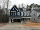 Two-story home with navy blue siding, covered porch, and attached two-car garage at 3267 Roundly Rd # 8, New Hill, NC 27562