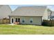 View of the home's backyard with a patio and a pair of wooden chairs at 3408 Cross Timber Ln, Raleigh, NC 27603