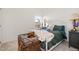 Charming bedroom with a white metal frame bed, decorative pillows, and a vintage trunk at 3408 Cross Timber Ln, Raleigh, NC 27603