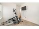 Functional exercise room with an elliptical machine, rowing machine, and mounted television at 3408 Cross Timber Ln, Raleigh, NC 27603