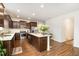 Modern kitchen with dark cabinets, stainless steel appliances, and a large island with seating at 3408 Cross Timber Ln, Raleigh, NC 27603