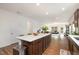 Open concept kitchen with a large island, white countertops, and stainless steel appliances at 3408 Cross Timber Ln, Raleigh, NC 27603