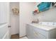 Efficient laundry room area with a washer, dryer, and shelving for storage at 3408 Cross Timber Ln, Raleigh, NC 27603