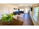 Open concept living room with dark sofas, a bright rug, hardwood floors, and natural light at 3408 Cross Timber Ln, Raleigh, NC 27603
