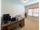 Office space with a wooden desk, multiple computer screens and a bright window with wood blinds at 3408 Cross Timber Ln, Raleigh, NC 27603