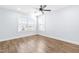 Spacious bedroom with wood floors and large windows at 6416 Truxton Ln, Raleigh, NC 27616