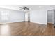 Bedroom with wood floors, ceiling fan, and walk-in closet at 6416 Truxton Ln, Raleigh, NC 27616