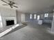 Open-concept living room featuring a fireplace, natural light, and a seamless flow to the kitchen at 102 Ruskin Dr, Smithfield, NC 27577