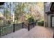 Wood deck with black railings offers wooded views at 106 Springbrook Pl, Cary, NC 27518