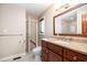 Full bathroom features a wood vanity, framed mirror, and updated fixtures at 106 Springbrook Pl, Cary, NC 27518