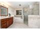 Spacious bathroom features double sinks, tub, and glass shower with tile surround at 106 Springbrook Pl, Cary, NC 27518