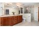 Bathroom features a large mirror, wooden cabinets, double sinks, and a glass shower at 106 Springbrook Pl, Cary, NC 27518