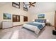 Bright bedroom features neutral colors, a ceiling fan, and a large window at 106 Springbrook Pl, Cary, NC 27518