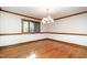 Open dining room space with hardwood floors, chandelier, and natural light from window at 106 Springbrook Pl, Cary, NC 27518