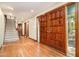 Grand foyer with hardwood floors, staircase, and natural light from large front door windows at 106 Springbrook Pl, Cary, NC 27518