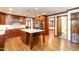 Open kitchen featuring hardwood floors, stainless appliances, granite countertops and island seating at 106 Springbrook Pl, Cary, NC 27518
