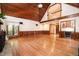 Open-concept living area featuring a stone fireplace, hardwood floors, and custom wet bar at 106 Springbrook Pl, Cary, NC 27518