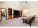 Living room features built-in shelves, a television, a sofa, and access to the bathroom at 106 Springbrook Pl, Cary, NC 27518
