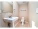 Neutral powder room features a pedestal sink, tile floors, and modern fixtures at 106 Springbrook Pl, Cary, NC 27518