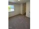 Comfortable bedroom with carpet, large window, and convenient access to a nearby closet and door at 1103 Mountain Crown St, Durham, NC 27703