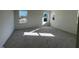 Spacious bedroom features ample natural light from multiple windows and neutral carpeting at 120 Parker Ln, Mebane, NC 27302