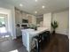 Open kitchen features gray cabinets, stainless steel appliances, and an island with seating at 120 Parker Ln, Mebane, NC 27302