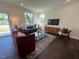 Inviting living room with a sofa, armchairs, and large windows for lots of natural light at 120 Parker Ln, Mebane, NC 27302