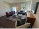 Cozy living room with sofa, armchairs, coffee table, and large windows with natural light at 120 Parker Ln, Mebane, NC 27302