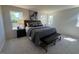 Spacious main bedroom with two windows, a bed with a padded bench, and two side tables at 120 Parker Ln, Mebane, NC 27302