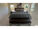 Bright and airy main bedroom featuring a large bed, bench, and side tables with lamps at 120 Parker Ln, Mebane, NC 27302