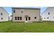 The backyard features a freshly seeded lawn and the rear exterior of the house at 1216 Dimaggio Dr # 29, Raleigh, NC 27616