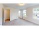 A bedroom with neutral walls, carpet floors and windows offering scenic views at 1216 Dimaggio Dr # 29, Raleigh, NC 27616