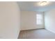 A carpeted bedroom with a window that provides ample natural light at 1216 Dimaggio Dr # 29, Raleigh, NC 27616