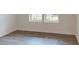 A cozy bedroom with a durable laminate wood floor and natural light at 1216 Dimaggio Dr # 29, Raleigh, NC 27616
