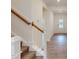 Welcoming entryway with wood-look flooring and stairs with white railing and natural wood bannister at 1216 Dimaggio Dr # 29, Raleigh, NC 27616